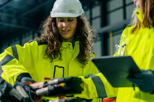 istock Safety-first approach in construction: workers collaborating on site with tools and equipment 2200559000