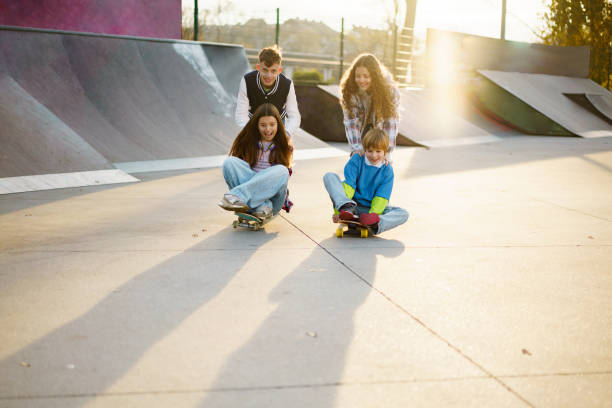 istock Children have fun skateboarding in the park 2200559293