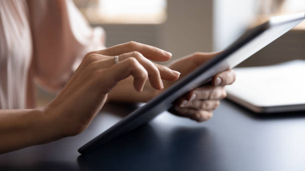 istock Closeup businesswoman hands holds tablet working using internet business app 2200561390
