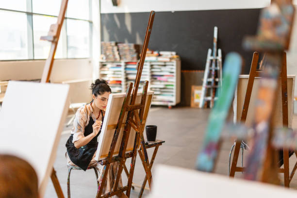 istock Focused Middle Eastern Female Artist in Art Class 2200566210