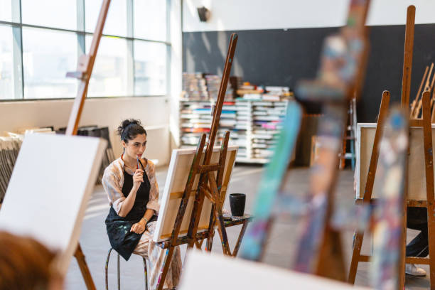 istock Focused Middle Eastern Female Artist in Art Class 2200566215