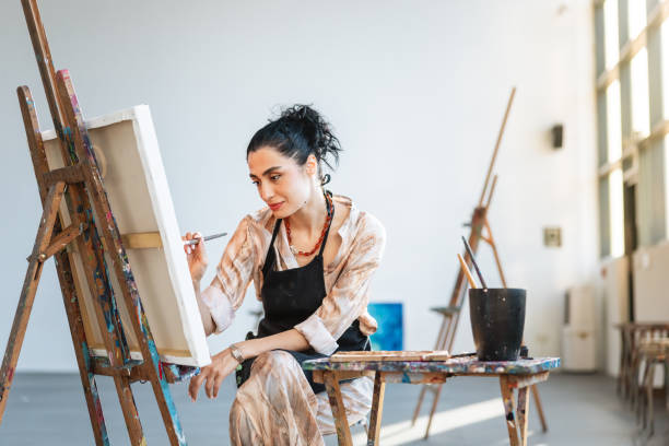 istock Determined Young Female Artist Creating in Modern Studio 2200566276
