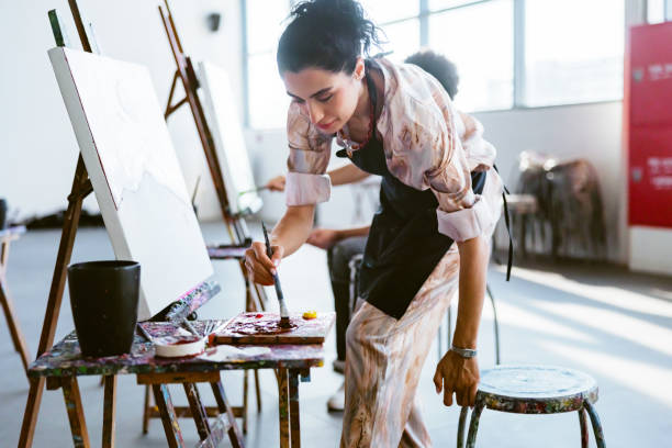 istock Focused Young Middle Eastern Female Painting in Art Class 2200566355