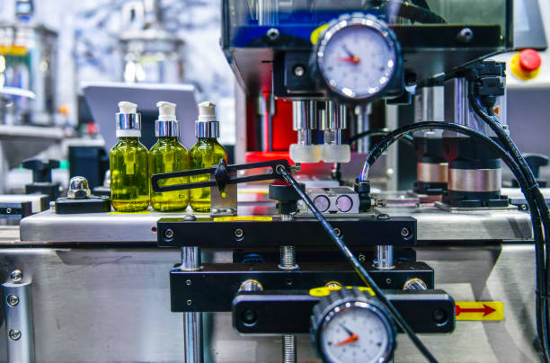 istock Glass bottles in a conveyor belt on a high quality automatic vertical filling machine. 2200568359