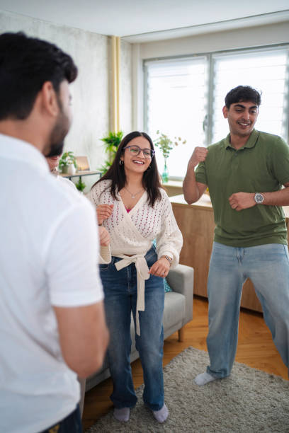 istock Young friends dancing and having fun together at home 2200570101