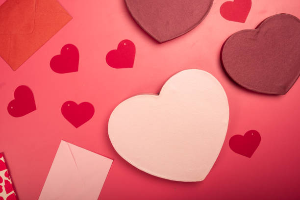 istock A flat lay Valentine's Day composition featuring heart-shaped gift boxes, paper hearts, envelopes, ribbons, and origami hearts on a red background, symbolizing love, romance, and celebration 2200570205