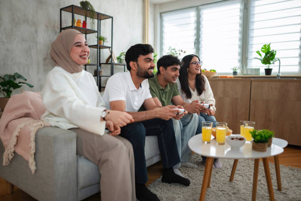 istock Four Young Adults Playing Video Games at Home 2200570283