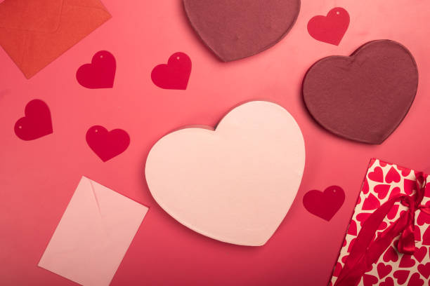 istock A flat lay Valentine's Day composition featuring heart-shaped gift boxes, paper hearts, envelopes, ribbons, and origami hearts on a red background, symbolizing love, romance, and celebration 2200570359