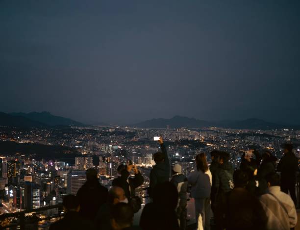 istock People at the mountain lookout at night 2200570646