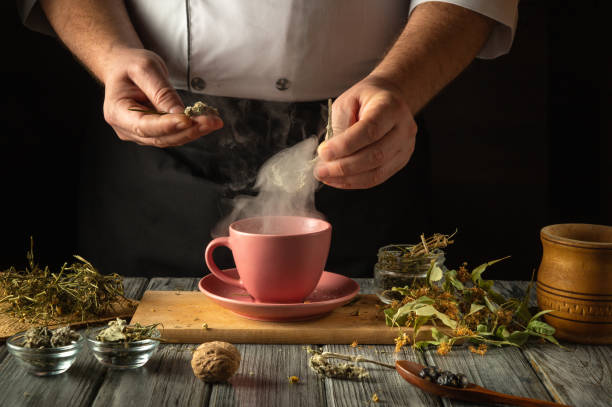istock An experienced herbalist prepares tea from dried medicinal herbs for the prevention of viruses and a set of vitamins. Hands masterfully add herbs to a mug of boiling water 2200571017