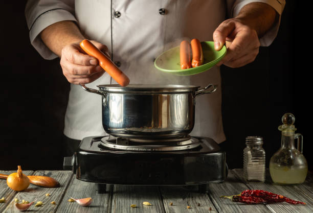 istock In a warm kitchen, a chef skillfully adds sausages to a pot, surrounded by fresh vegetables and spices, creating a delightful meal. The atmosphere is inviting and aromatic 2200571093