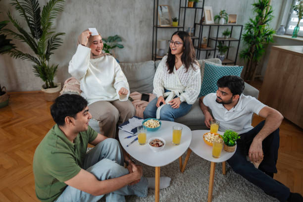 istock Group of Young Adults Playing Guessing Game at Home 2200571946