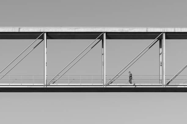 Germany, Berlin, Paul-Löbe-Haus, October 17, 2024 - Low angle view of one person passing a modern footbridge