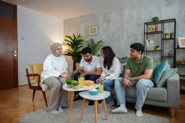 istock Young multiracial students sharing content on smartphone at home 2200572380