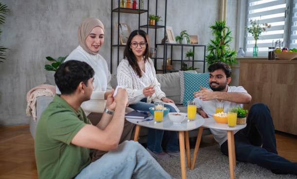 istock Group of multiracial students playing charades at home 2200572390