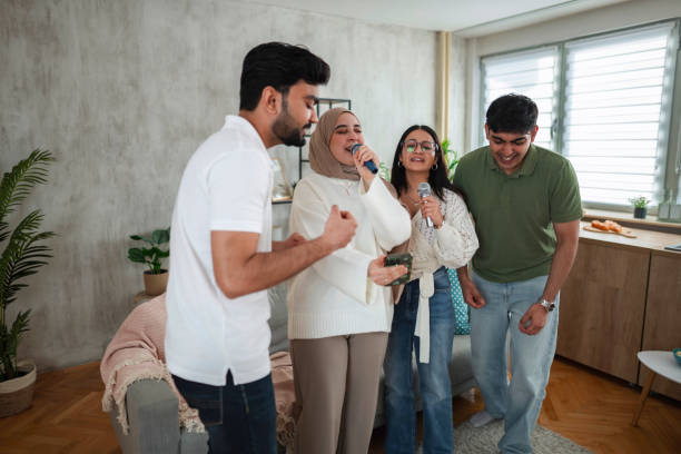 istock Four Young Adults Singing Karaoke at Home 2200572461