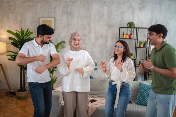 istock Multiracial students dancing together in the living room 2200572480
