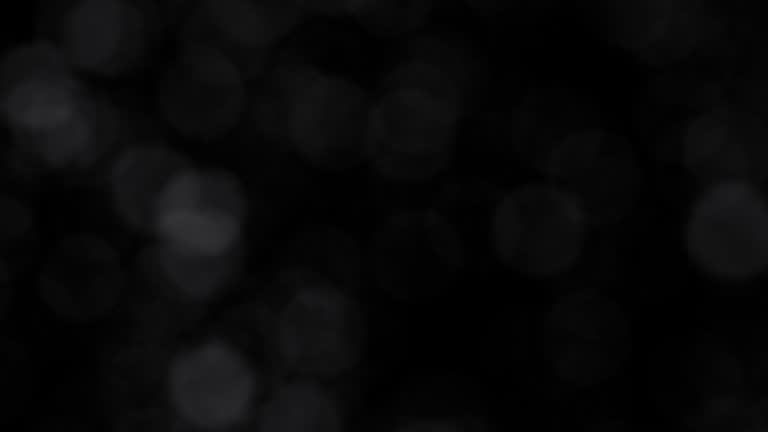 Super Slow Motion Shot of Small Particles Flying in the Air Isolated on Black