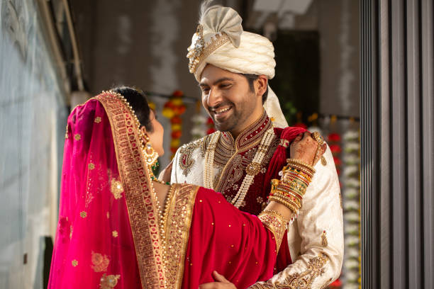 istock Loving groom looking at bride in wedding ceremony 2200577487