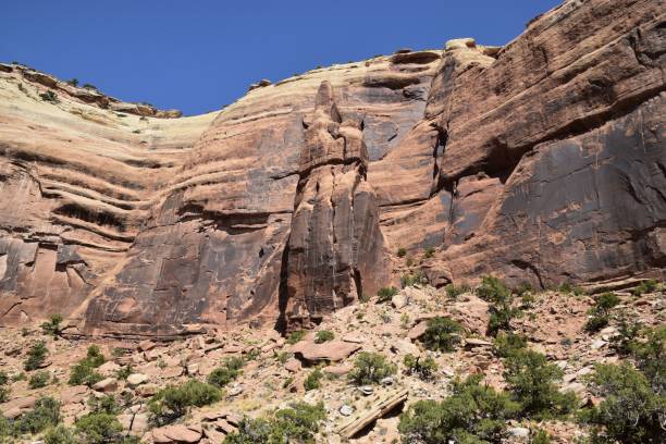 istock Rocky canyon wall under a blue sky, showcasing natural erosion patterns. Colorado National Monument 2200579628