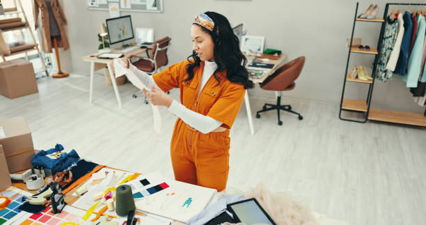 istock Decision, creative and fabric with fashion designer woman in textile workshop for material choice. Clothing industry, table and texture with style director in office for manufacturing or production 2200584341