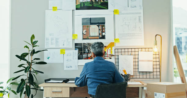 istock Back, woman or idea in office for architecture, design process or blueprint for housing development. Mature engineer, moodboard or creative at desk for building renovation, project management or plan 2200585532