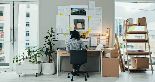 istock Back, woman or planning in office for architecture, design process or blueprint for housing development. Engineer, moodboard or creative at desk for building renovation, project management or ideas 2200585548