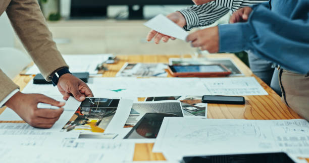 istock Architects, hands and design meeting with documents, planning and agency for creative partnership. Business people, tablet and engineering for blueprint, brainstorming or problem solving for startup 2200585633