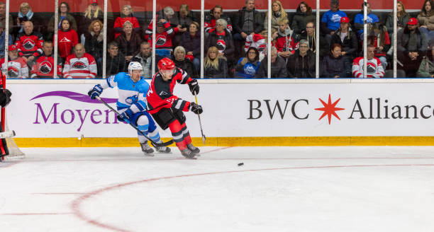 istock Intense Ice Hockey Match Between Rival Teams in Packed Arena 2200585890