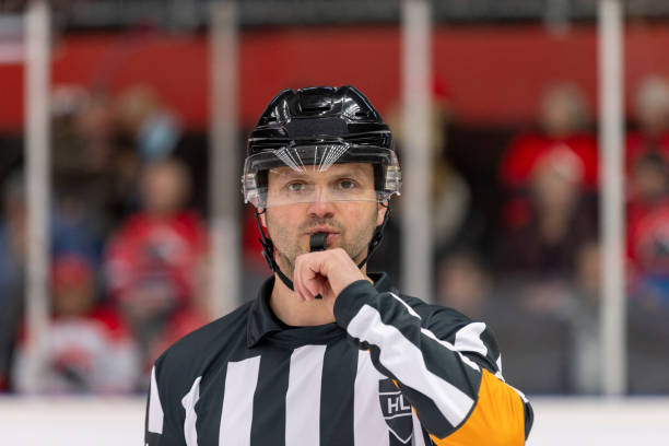 istock Caucasian Male Referee Blowing Whistle During Ice Hockey Game 2200585900