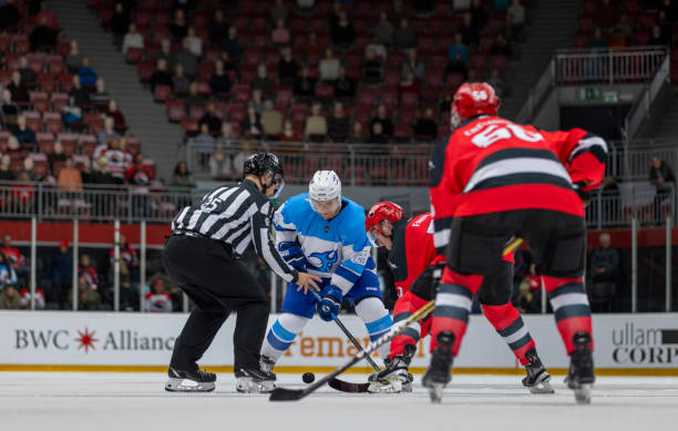 istock Intense Ice Hockey Faceoff Between Opposing Teams in Arena 2200586013