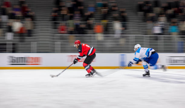 istock Dynamic Ice Hockey Match with Intense Player Action 2200586137