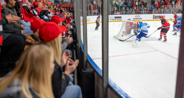 istock Intense Ice Hockey Game with Enthusiastic Crowd Cheering 2200586494