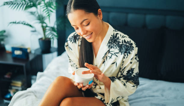 istock Woman at home using shea butter body cream 2200587391