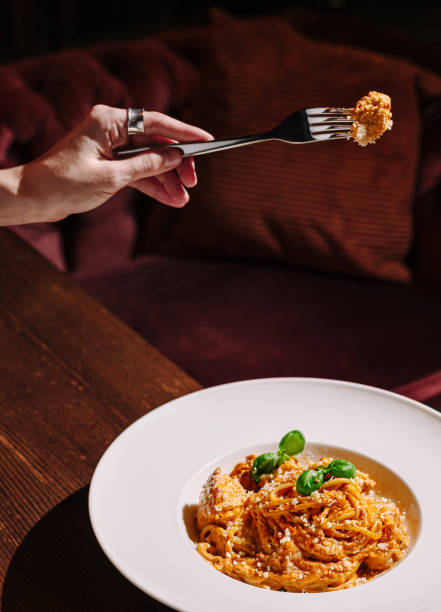 istock Beautifully plated pasta dish being enjoyed in a cozy dining setting with warm lighting 2200589190