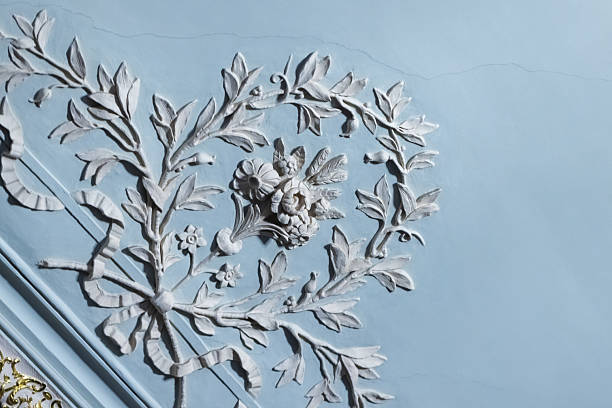 istock Detailed white floral decoration placed over light blue ceiling 2200589359