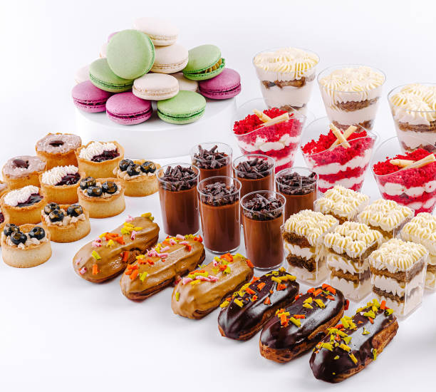 istock Delightful dessert spread featuring layered treats, pastries, and colorful macarons at a festive gathering 2200590422