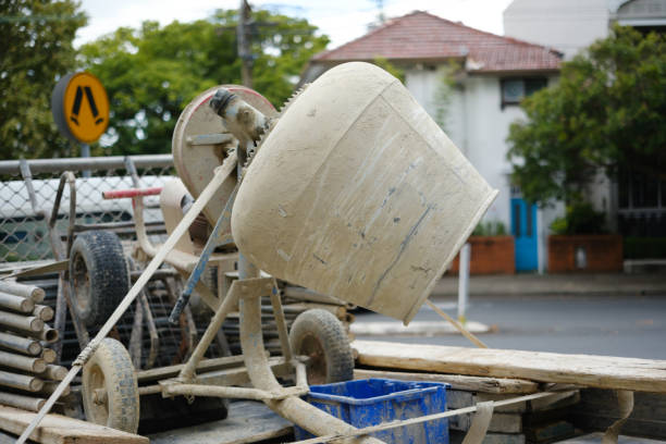 Portable cement mixer on the back of a truck.