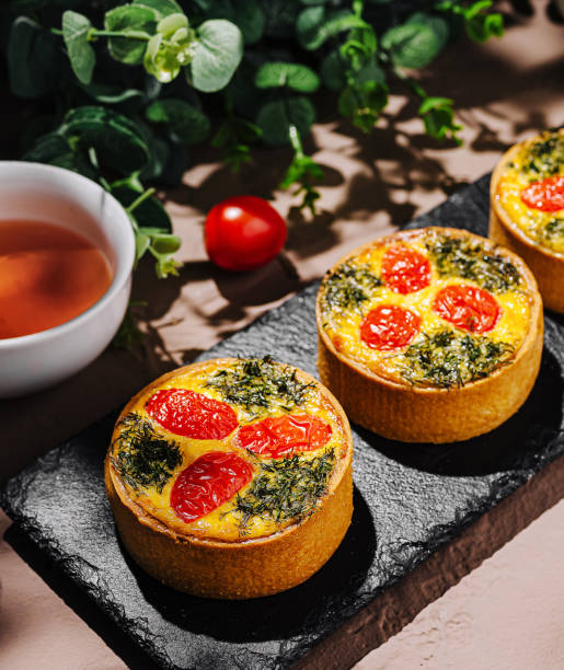 istock Savory tarts with tomatoes and herbs on slate serving board 2200593045
