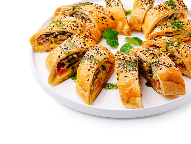istock Freshly baked savory rolls arranged beautifully on a white platter with sesame seeds and herbs 2200593113