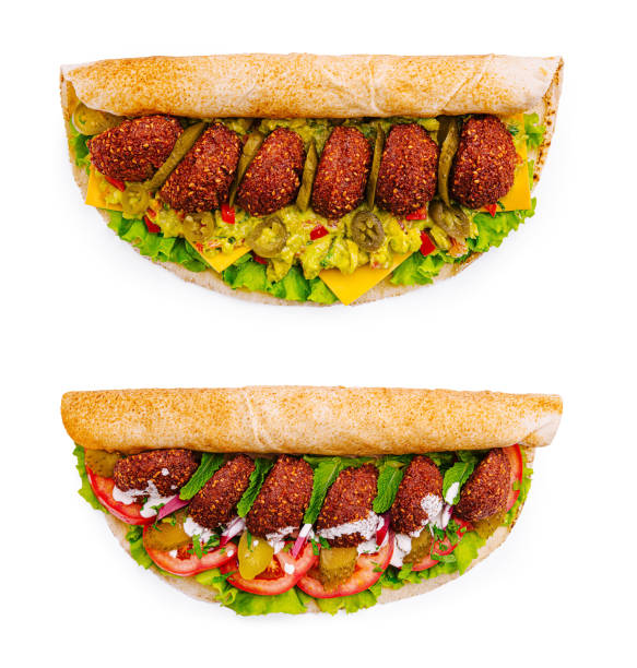 Healthy falafel wrap filled with fresh vegetables served on a white background