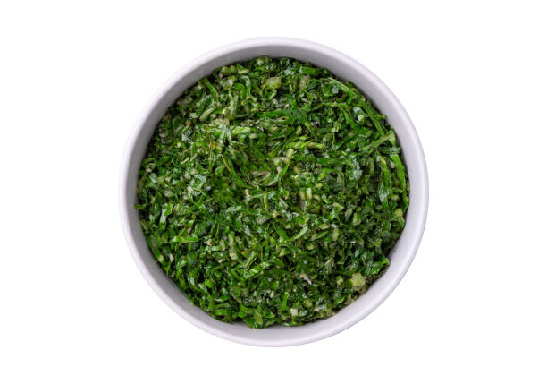 istock Cooked kale strips, typical brazilian feijoada sidedish in a bowl isolated over white background 2200597467