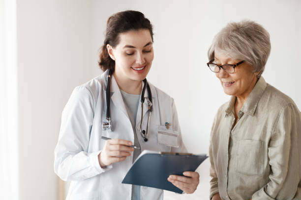 istock patient with a doctor in medical office 2200603518