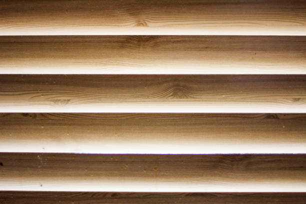 Sunlight coming through venetian blinds by the window