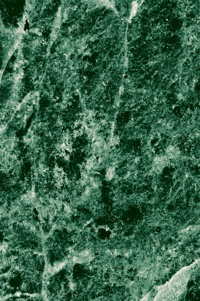 istock Real closeup of dark green marble stone texture surface background. Design pattern with high resolution for luxury home decoration. Abstract matt slab rock material. Front view of natural tiles stone surface. 2200611029