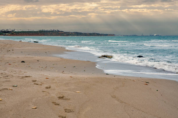 wide sandy sea beach at the bright hot summer sunny day , seasonal sea vacation scene