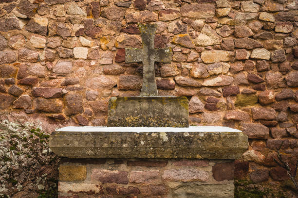 Rustic Stone Cross at a cemetery.