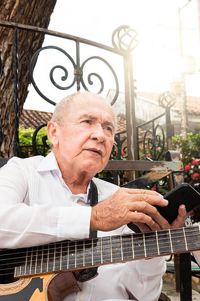 istock Old colombian man using a black smart phone in Colombia 2200612218