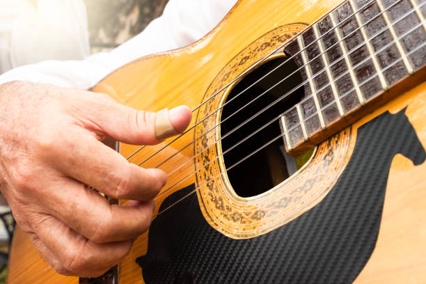 istock Hands of an unrecognizable man playing an acoustic guitar 2200612222