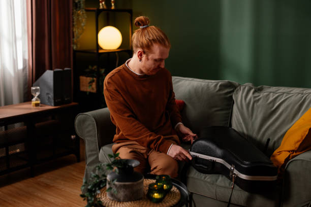 istock Musician preparing his instrument case at home 2200612735